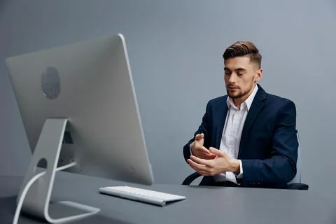 A man in a suit emotions problems with documents on the table technologies Stock Photos