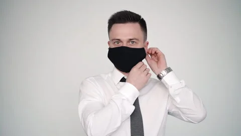 Man in suit fixing protective mask preventing from coronavirus flu disease. male Video stock 133221677