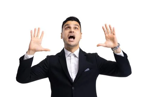 Man in a suit gestures with hands raised while speaking with emotion against a Stock Photos