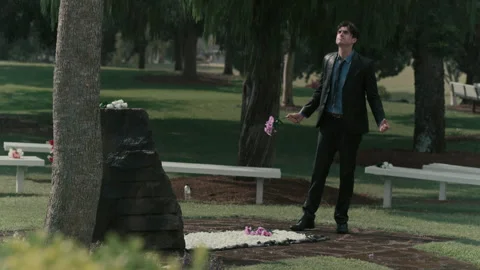 A man in a suit grieving at a funeral Stock Footage 262307269