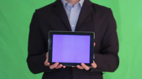 Man in suit holding up bluescreen tablet Stock Footage 40960564