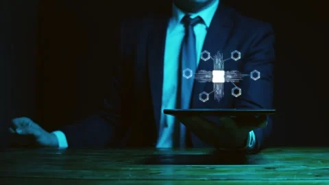 A man in a suit holds a graphics tablet above which is a hologram with moving Stock Footage 278318721