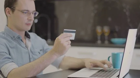 Man suit inserting credit card number on laptop Stock Footage 80696337