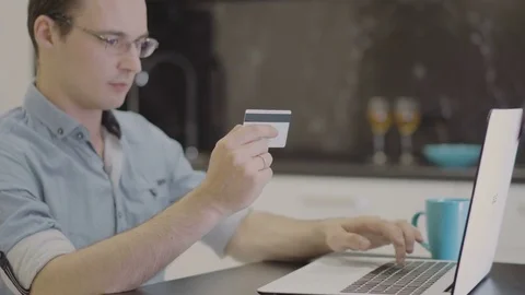 Man suit inserting credit card number on laptop Stock Footage 80846704