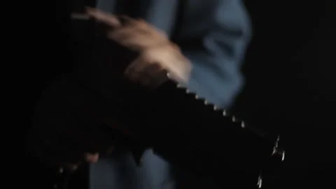 A man in a suit loading his gun, dark stealth kill environment Stock Footage 251766855