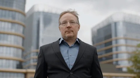 Man in suit look in camera outside office modern buildings business district Stock Footage 107901386