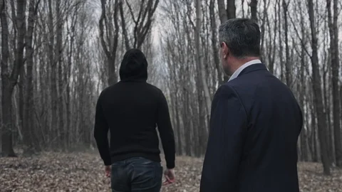 A man in suit points the gun to a running man which trying to ecape and save his Stock Footage 105560325