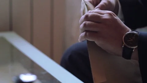 Man in suit ppaperovyy opens the envelope and pulls out a letter Stock Footage 71474581