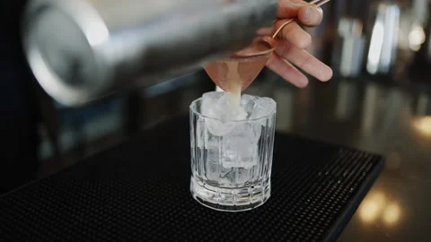 A man in a suit is preparing a drink at a bar Stock Footage 295993908