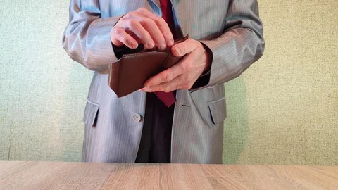 A man in a suit pulls a wallet out of his jacket. Stock Footage 101735705