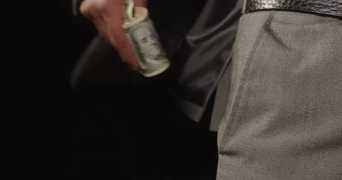 A Man In A Suit Puts Dollars In His Pocket. Corruption Stock Footage 165950063