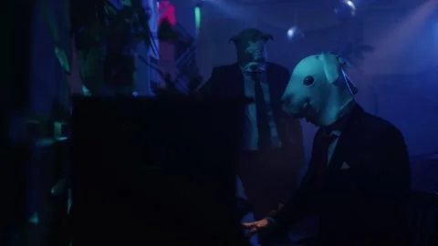 A man in a suit with rabbit mask playing a piano at the blue club Stock-Footage 259040378