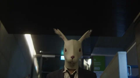 A man in a suit with rabbit mask walking Stock-Footage 259661704
