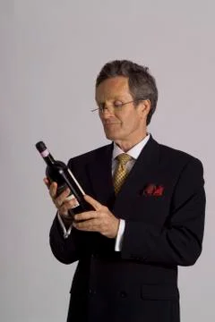 Man in suit samples wine Stock Photos