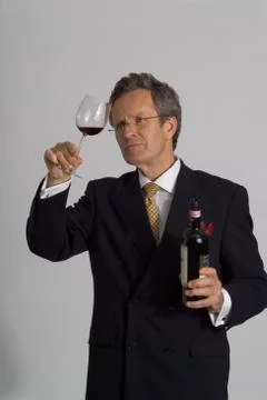 Man in suit samples wine Stock Photos