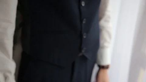 Man in suit setting up his watch Video stock 108560641