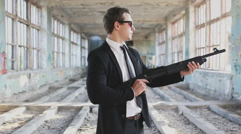 Man in a suit with a shotgun Stock Footage 66859960