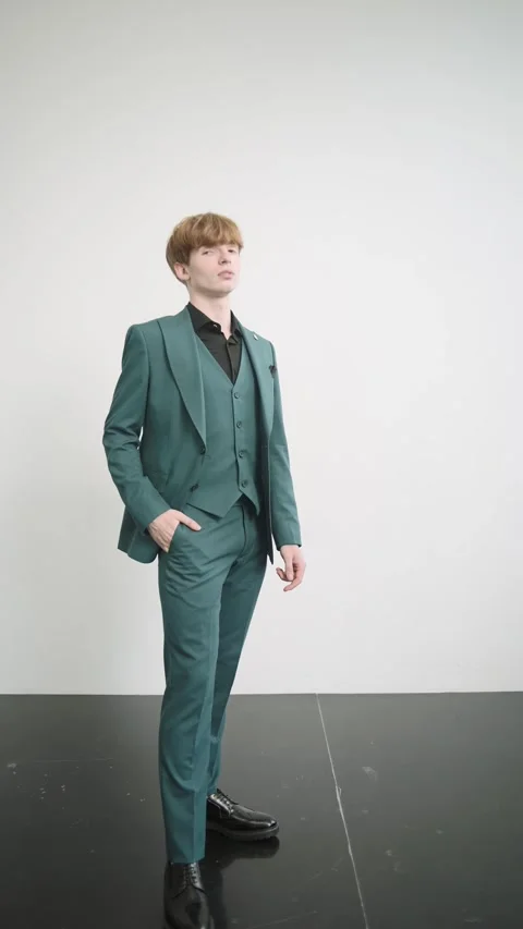 Man in suit standing on black surface in studio Stock Footage 277568658