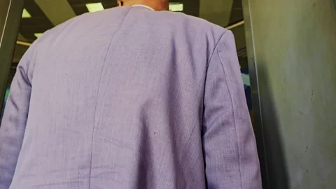 A man in a suit is standing in front of a bus Stock Footage 292236225