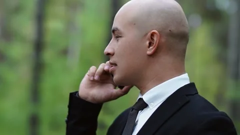 A man in a suit talking on the phone Stock Footage 147328608