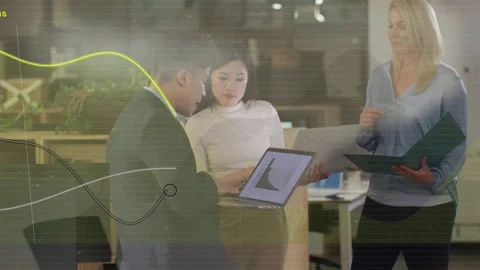 Man in suit tapping laptop, team leaning, nodes growing on screen, guiding Stock Footage 333318312