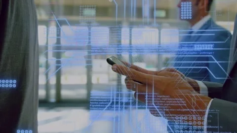 Man in suit tapping phone in lobby, initiating shifting circuit grid overlay Stock Footage 335762002