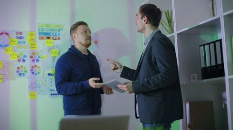 The man in a suit tells the second men an essence of the work Stock Footage 62550141