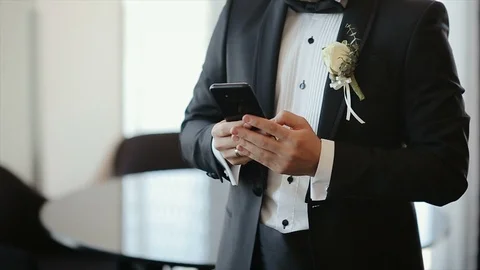 Man in Suit Using his Phone. Groom Texting Massage. Smartphone Stock Footage 111578345