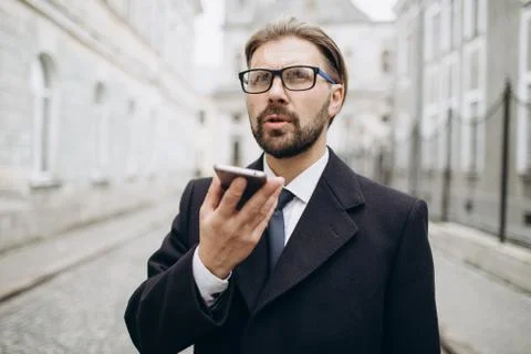 Man in suit using mobile for conversation Stock Photos