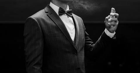 Man in suit using perfume Stock Photos