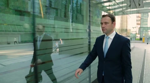 Man in a suit walking down the street Stock-Footage 68385178