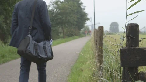 Man In Suit Walking On A Road Stock Footage 126985074