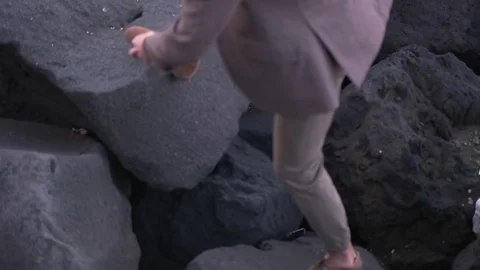 Man in suit walking on the rocks Stock-Footage 71916015