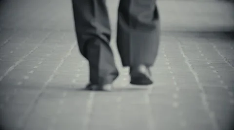 Man in suit walks down brick path 스톡 동영상 48207790