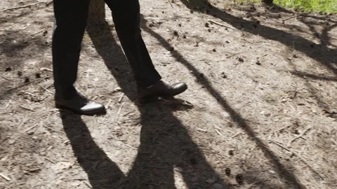 A man in a suit walks through the forest Video stock 306148920