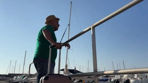 Man with suitcase overlooking Altea marina Stock Footage 341477939