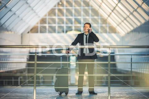 The man with a suitcase phone in the business center Stock Photos