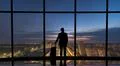 The man with suitcase standing near the big windows in the business center Photo