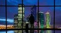 The man with suitcase standing near the big windows in the business center Photo