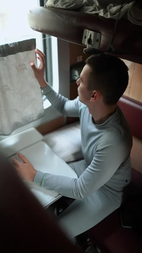 A man in a suitcase is on a train and is going uphill Stock Footage 324758959