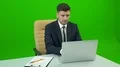 The man with a suitcase working at the desk on the green background 4k or 4k+ Resolution