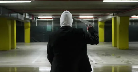 Man in a Suite with a White Mask Pointing a Gun to his Head Stock Footage 221963761