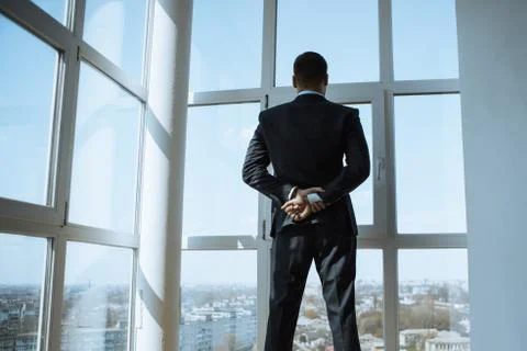 A Man in Suite at the Window Stock Photos