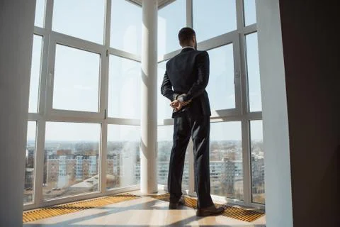 A Man in Suite at the Window Stock Photos