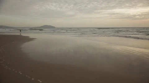Man in summer clothes on a beach. Sea waves, beautiful bay and endless sky. Stock Footage 44265459