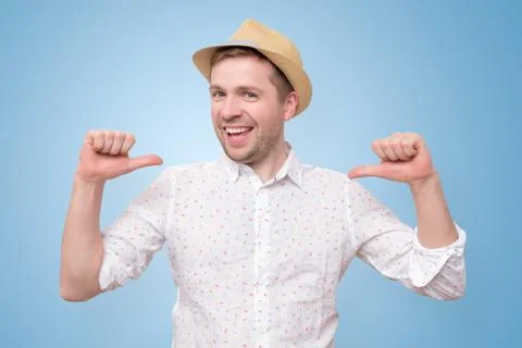 Man in summer hat looking confident with smile on face pointing on himself Stock Photos