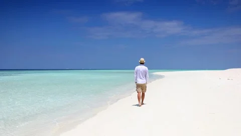 Man on summer holidays walks down alone a tropical paradise beach Video stock 263917270