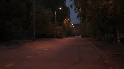Man in summer night, with a backpack goes on road Stock Footage 54917229