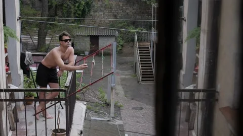 Man sunbathing on the balcony Stock Footage 194514424