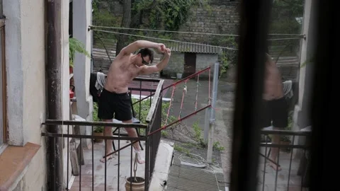 Man sunbathing on the balcony Stock Footage 195052490
